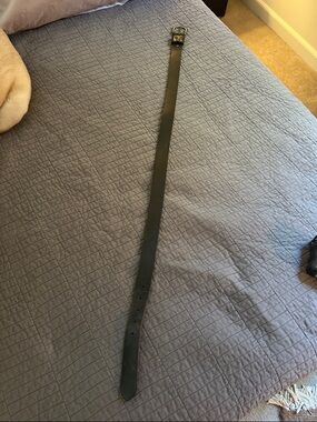 Black Leather Belt on Blue Quilt Bedding - Home Accent